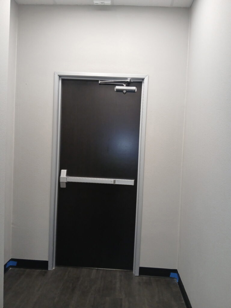 Interior commercial door with exit device and door closer
