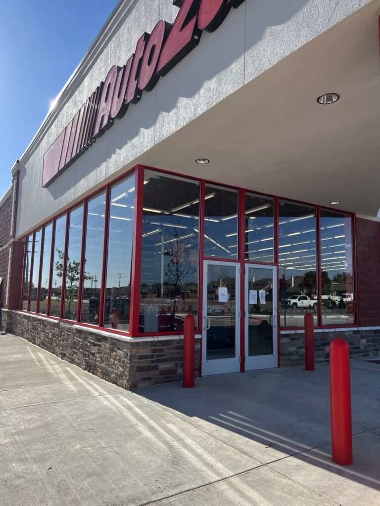 AutoZone storefront with red framing and commercial glass entrance