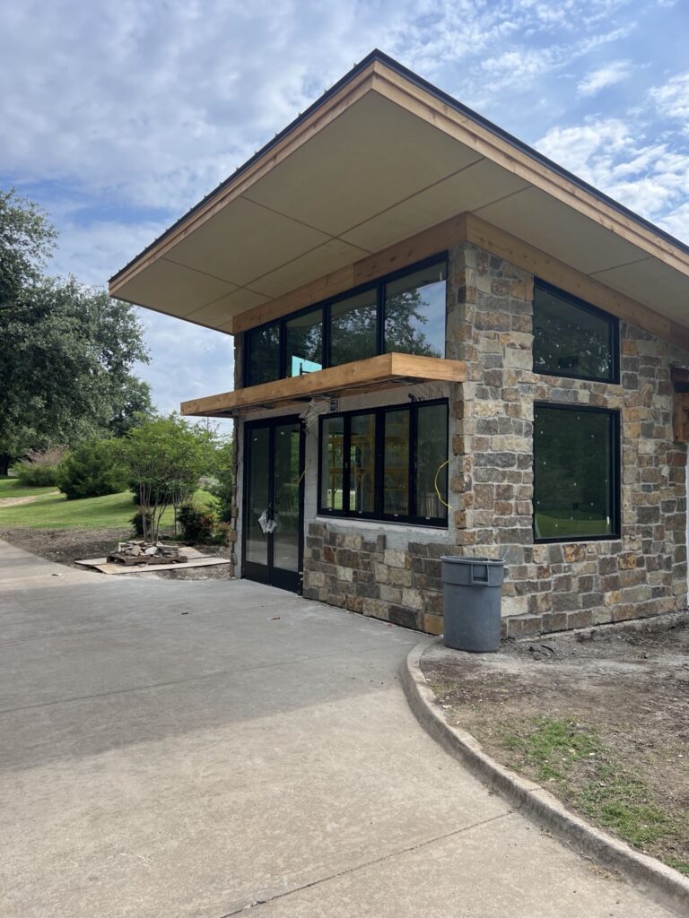 Commercial glazing and entrance in a stone-clad building