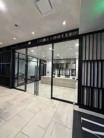 Commercial glass office entrance with black framing and double glass doors