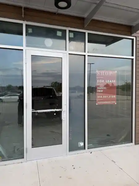Commercial aluminum storefront with glass entrance and large glass panels